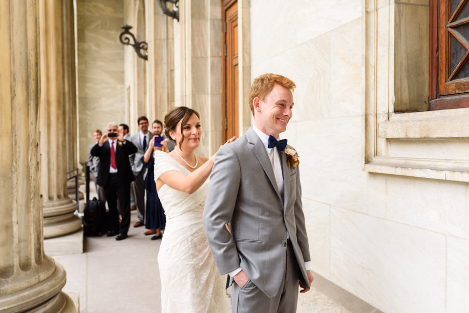 Bride tapping the groom on the shoulder 