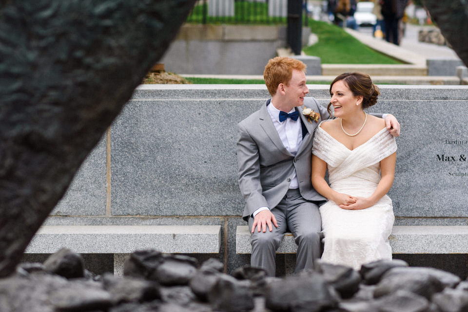 Newlyweds sitting in front of Montreal museum of fine arts