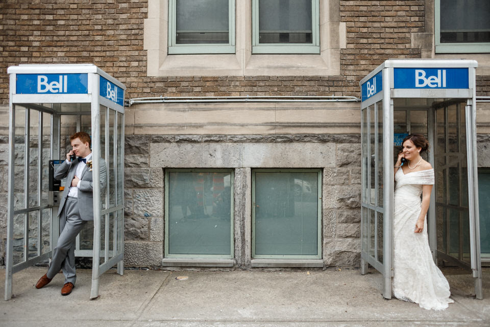 Bride and Groom posing in a phone booth