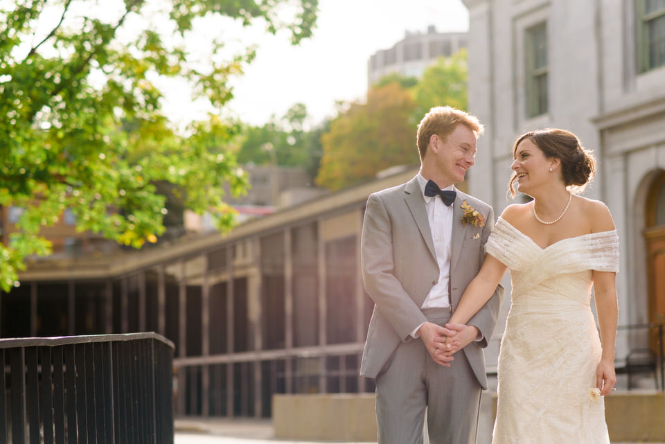 Newlyweds holding hands in the sun