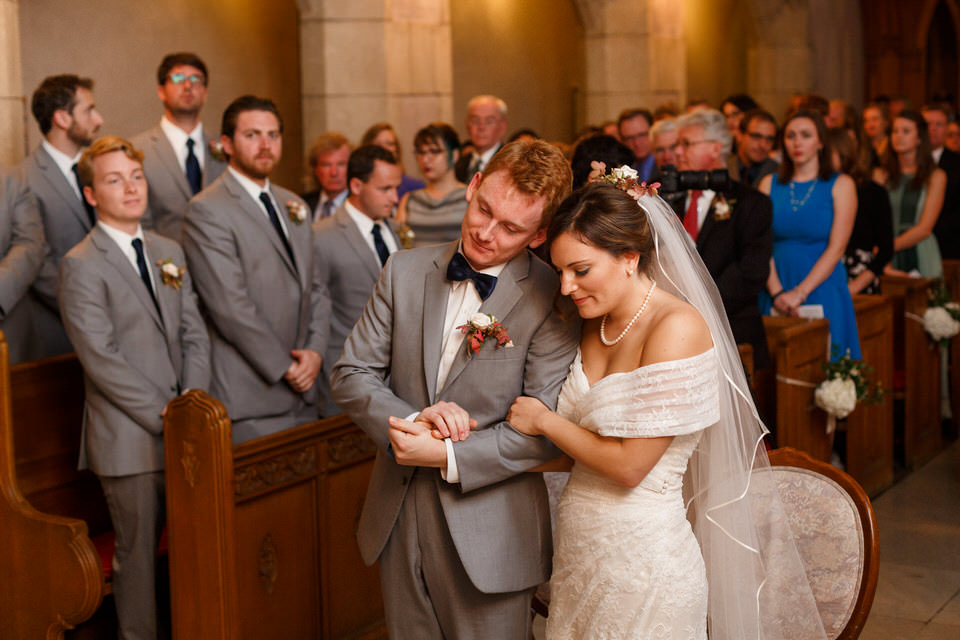 Wedding couple praying together in church