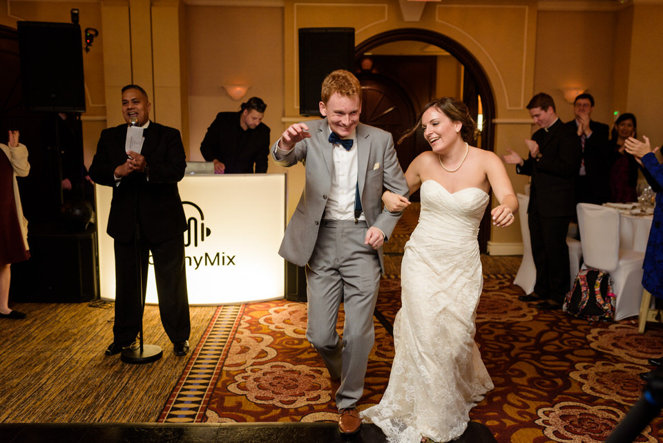 Married couple entering wedding reception at Loews Hotel Vogue