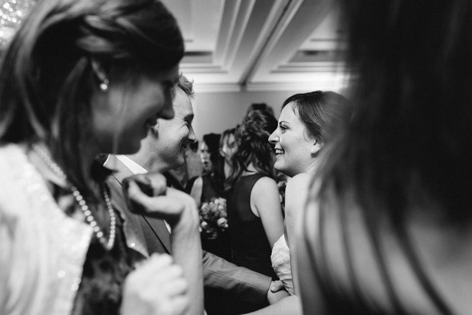 Newlyweds dancing with friends 