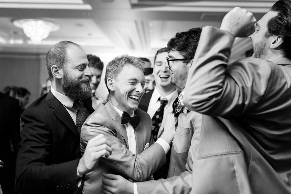 Happy groom surrounded by friends