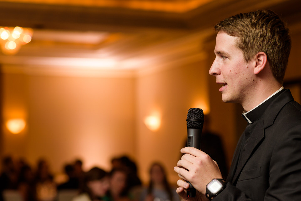 Priest praying before meal 