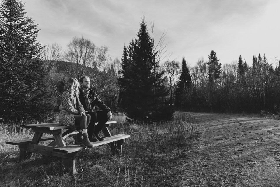 Black and white photo of couple on picnic bench at Mont-Tremblant