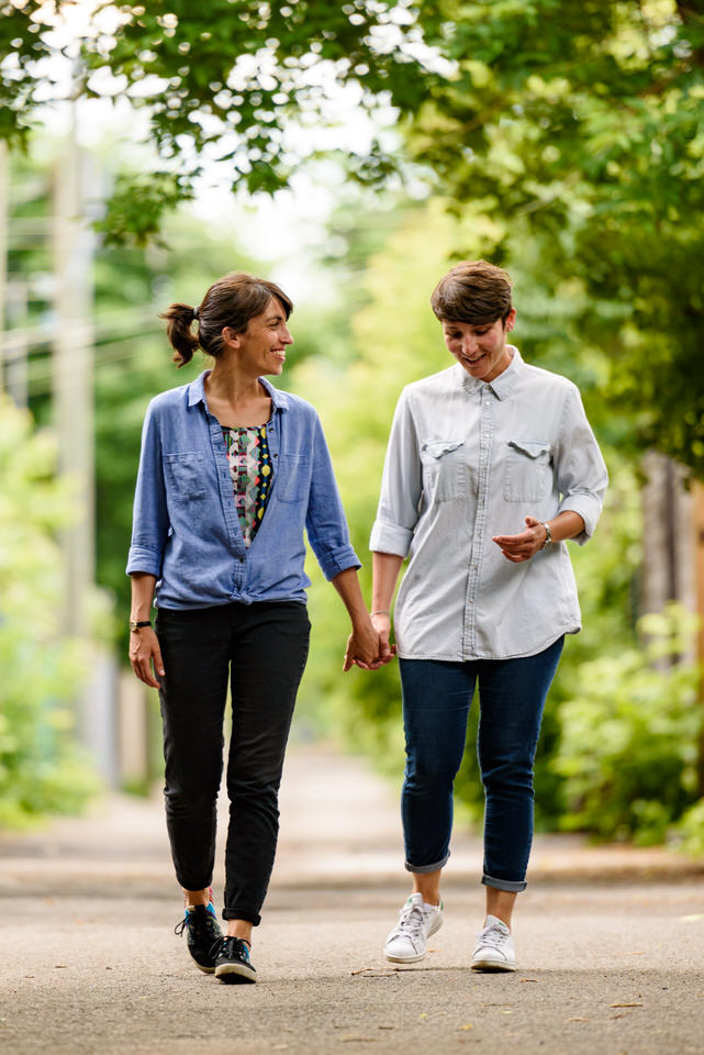 Same-sex couple walking in Montreal's green alleyways