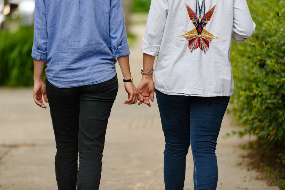  Lesbian couple holding hands and strolling