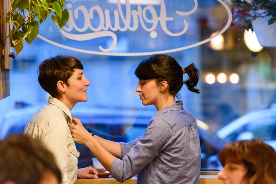 Romantic photo at Montreal cafe for lesbian couple 