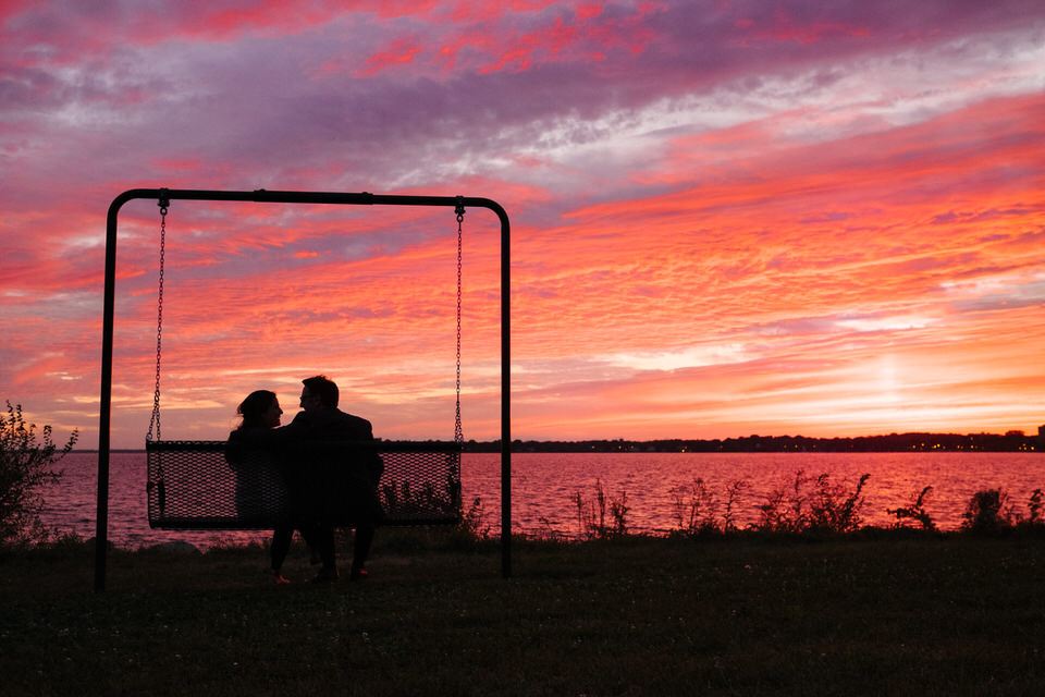 Happy newly engaged couple after sunset proposal near saint lawrence river