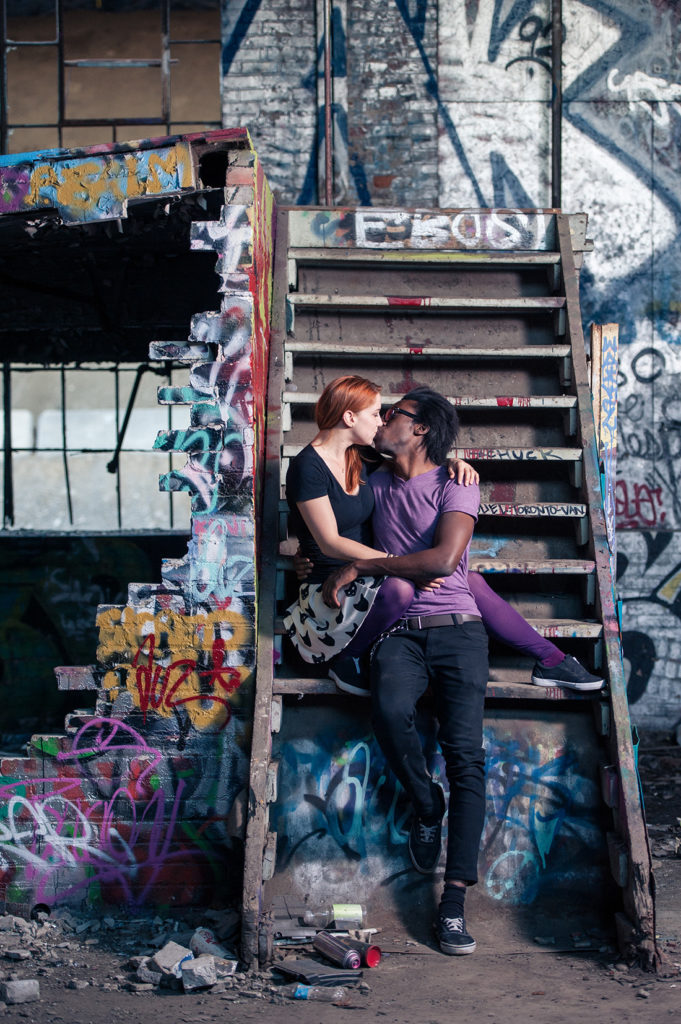 Urban engagement photoshoot in graffiti covered building