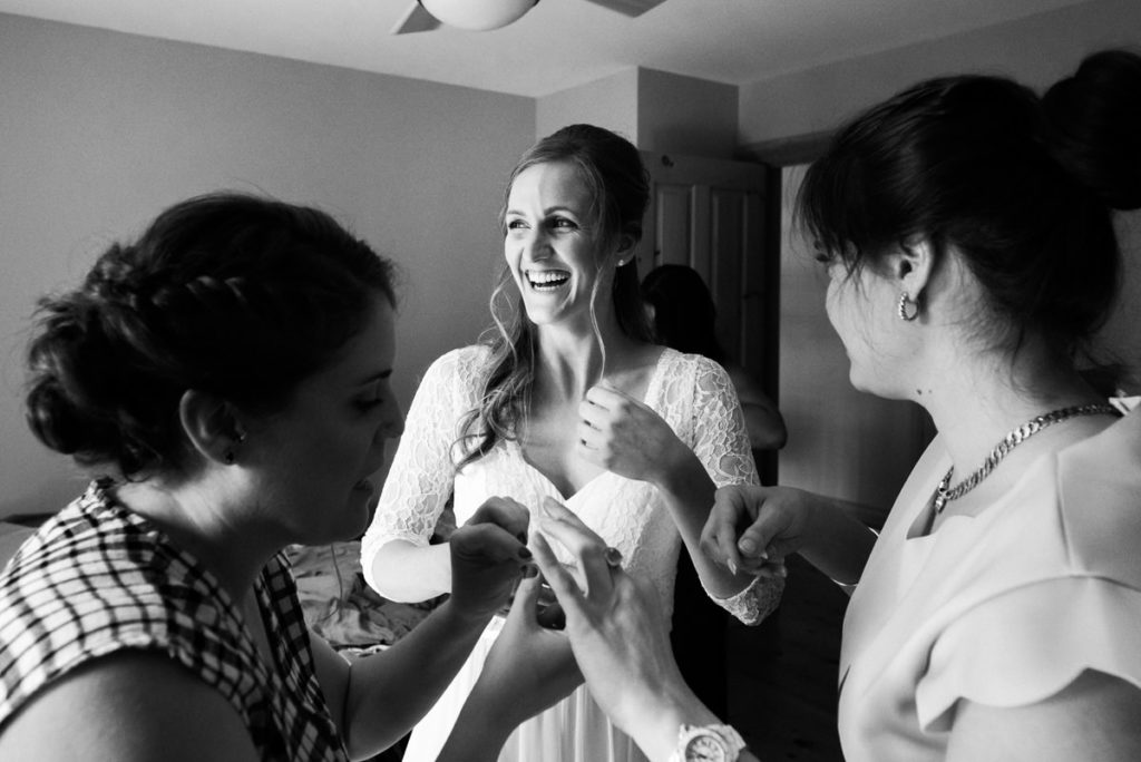 Photojournalistic coverage of bride getting ready with friends