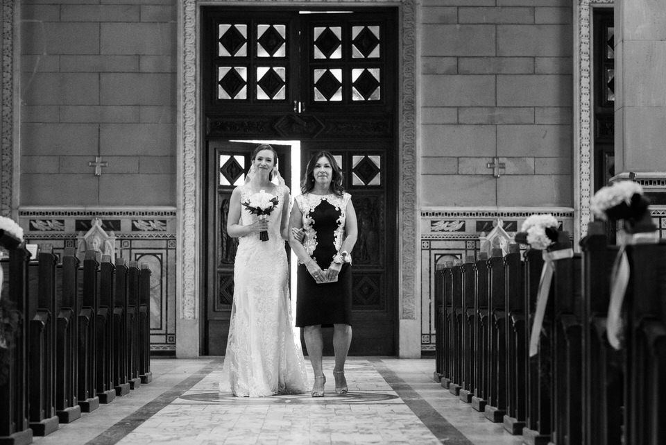 bride and her mother walking up the church aisle