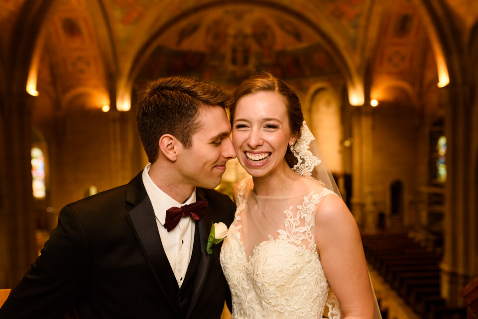 Wedding couple kissing in church after ceremony