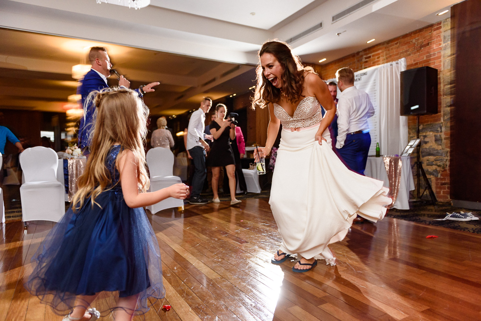 Bride dancing with flower girl