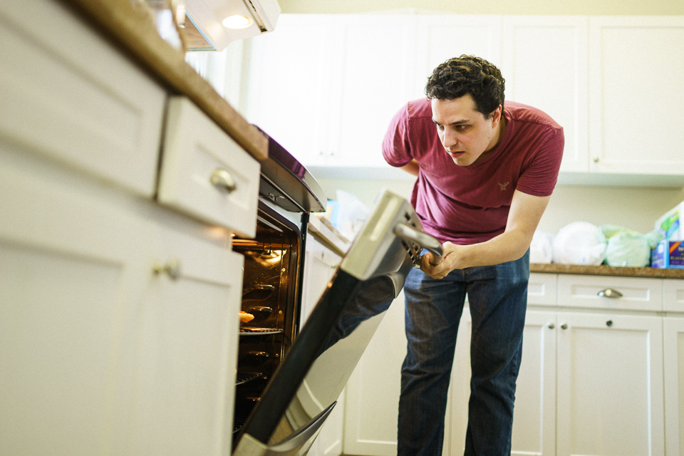 Groomsman opening oven door