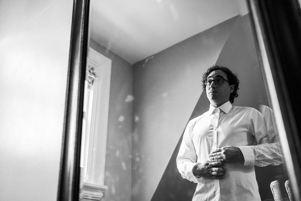 Groom getting ready in mirror