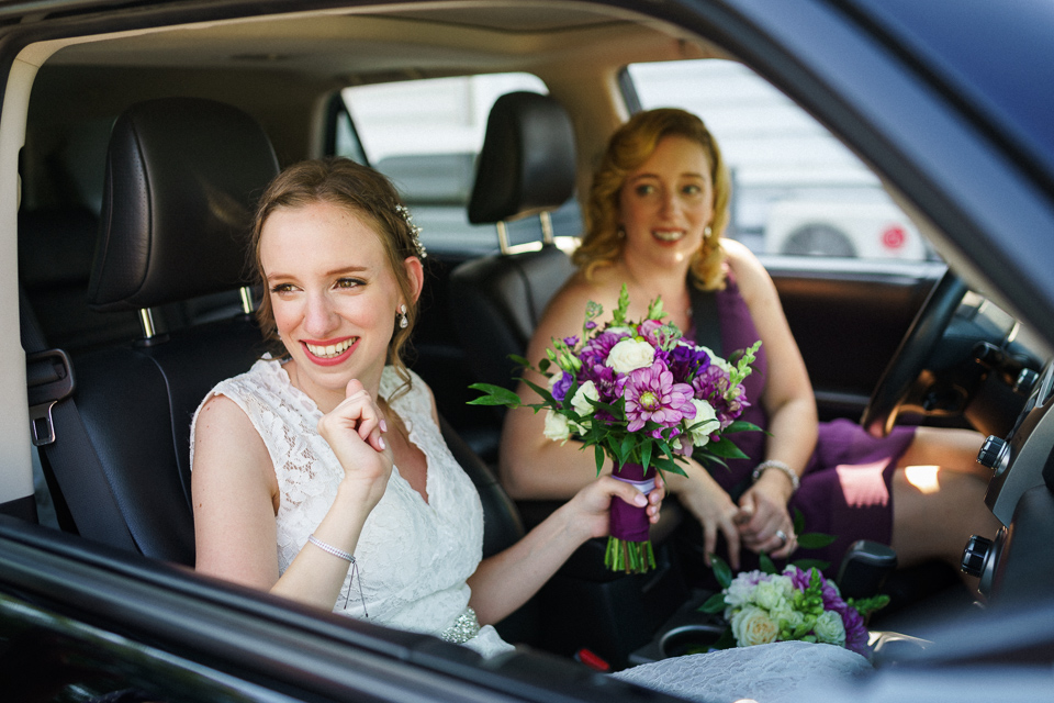 Bride arriving in car with sister