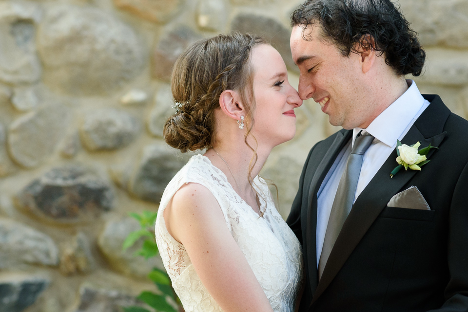 Close up of bride and groom nose to nose smiling