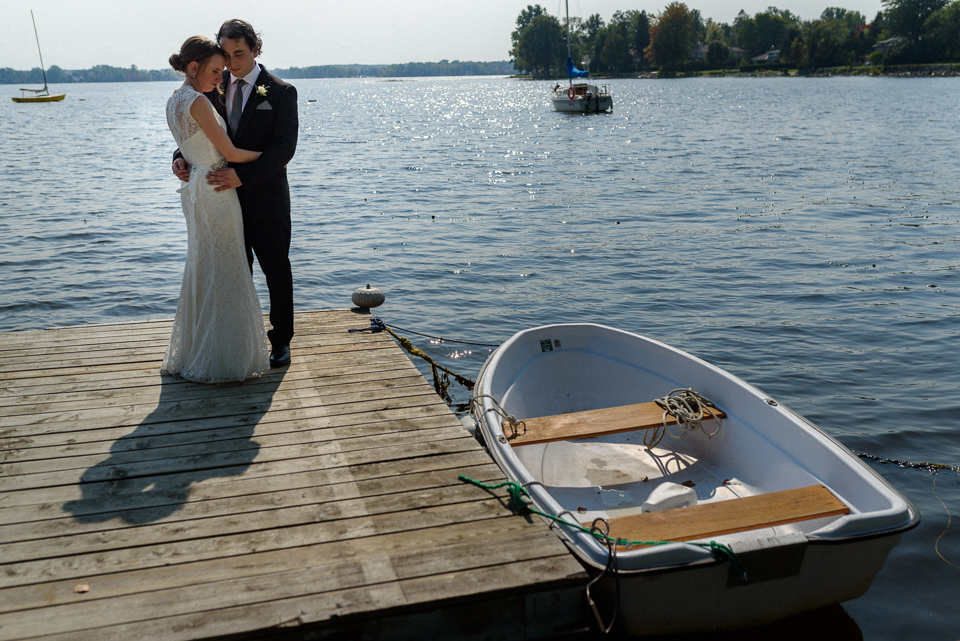 Wedding couple on a dock next to row boat