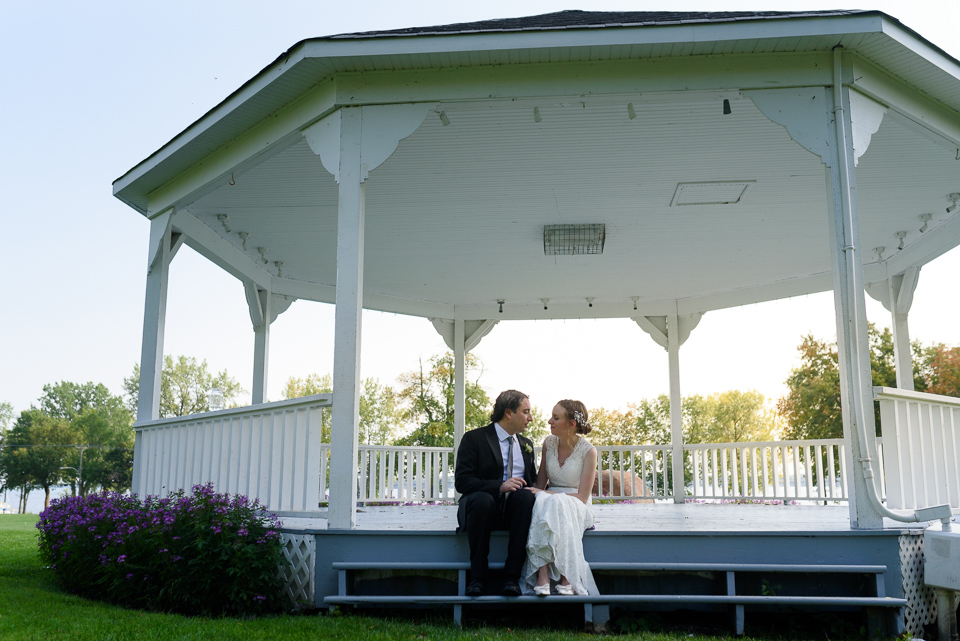 Bride and groom sitting on gazebo steps