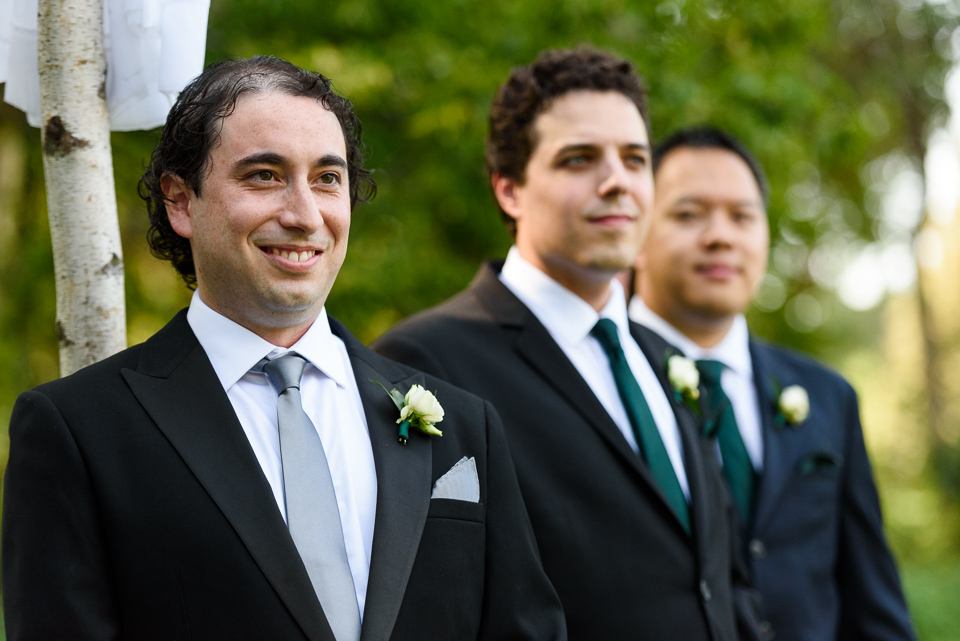 Groom watching bride arrive