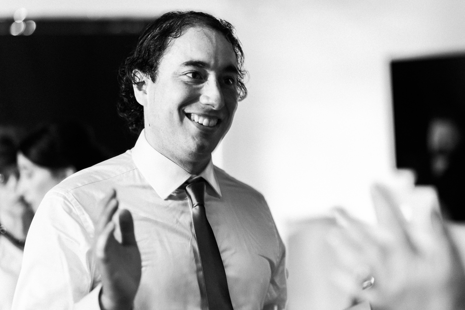 Groom clapping at wedding reception