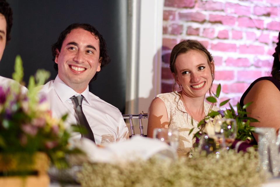 Wedding couple listening to speech