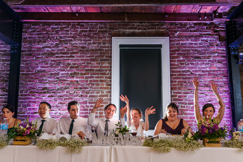 Wedding party singing a song at dinner at Canvas Loft Reception hall