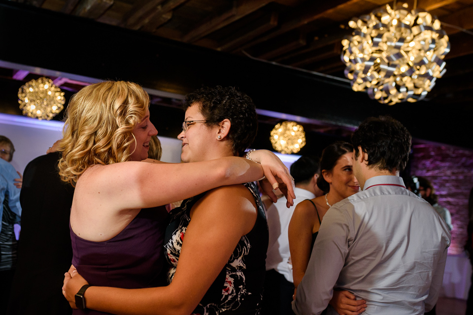 Bride's sister and her wife dancing