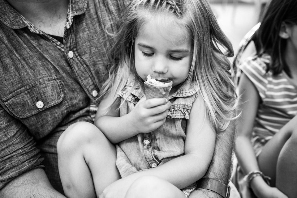 Child eating ice cream in documentary family photo