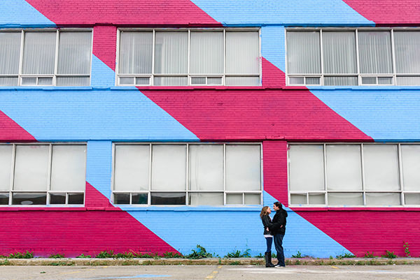 Engagement portrait at colourful striped building