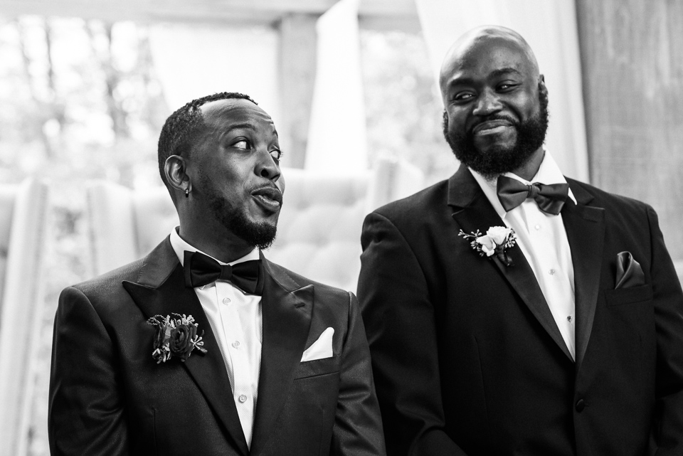 Groom joking with his best man at ceremony