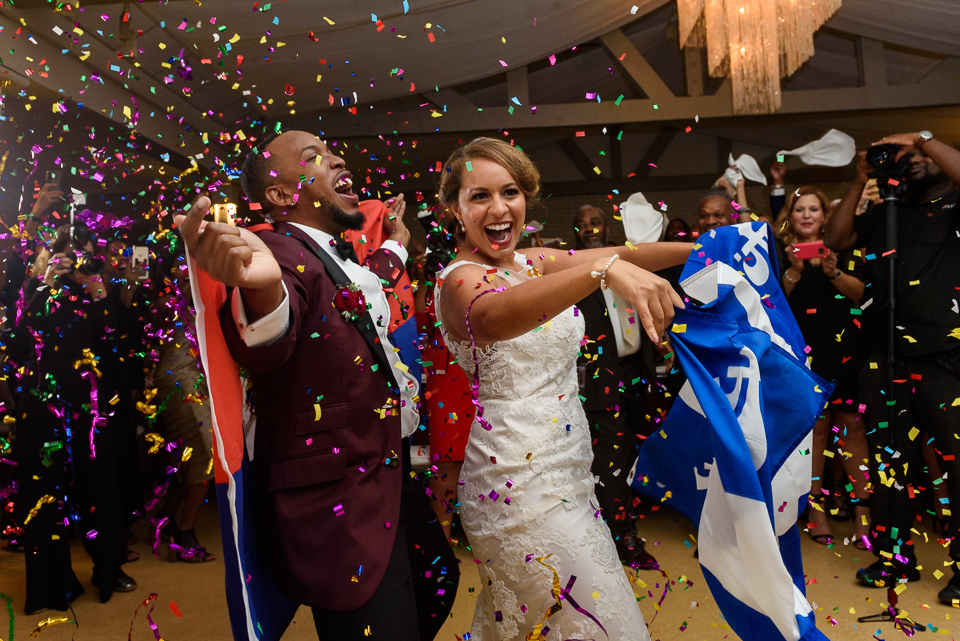 Bride and groom dancing with confetti and flags at Chalet des Erables wedding