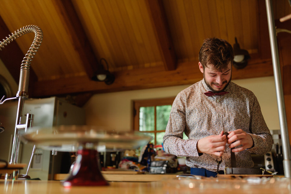 Groomsman fixing a broken suspender