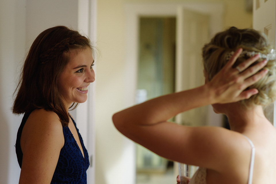 Bridesmaid smiling at bride