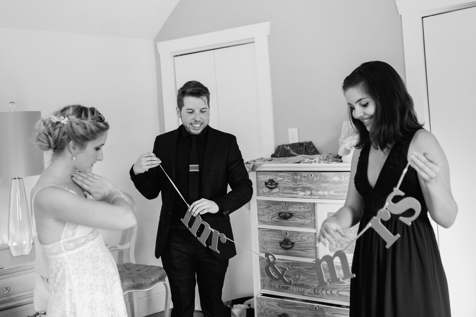 Friends of the bride showing her a mr & mrs banner decoration