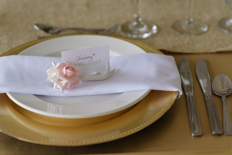 Small ceramic rose and antler wedding place card holder