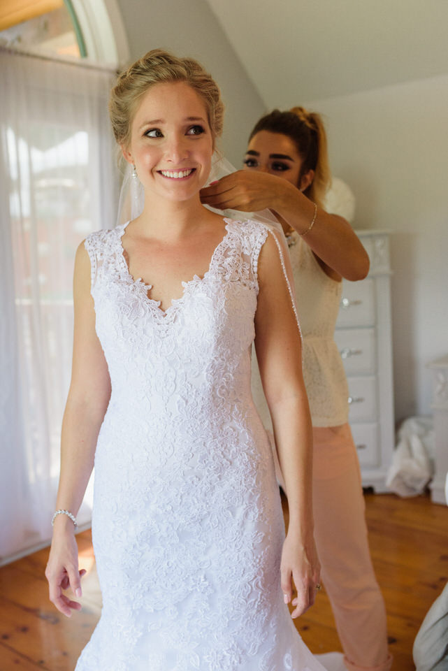 Nervous bride getting her veil pinned on