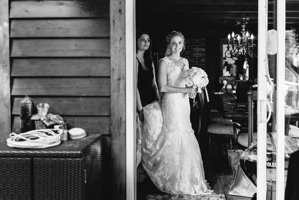 Bride peeking out doorway before wedding ceremony