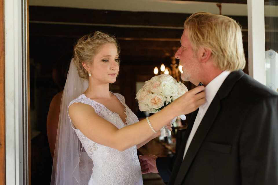 Daughter adjusting her father's bow tie