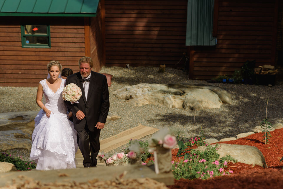 Bride and father walking up stairs