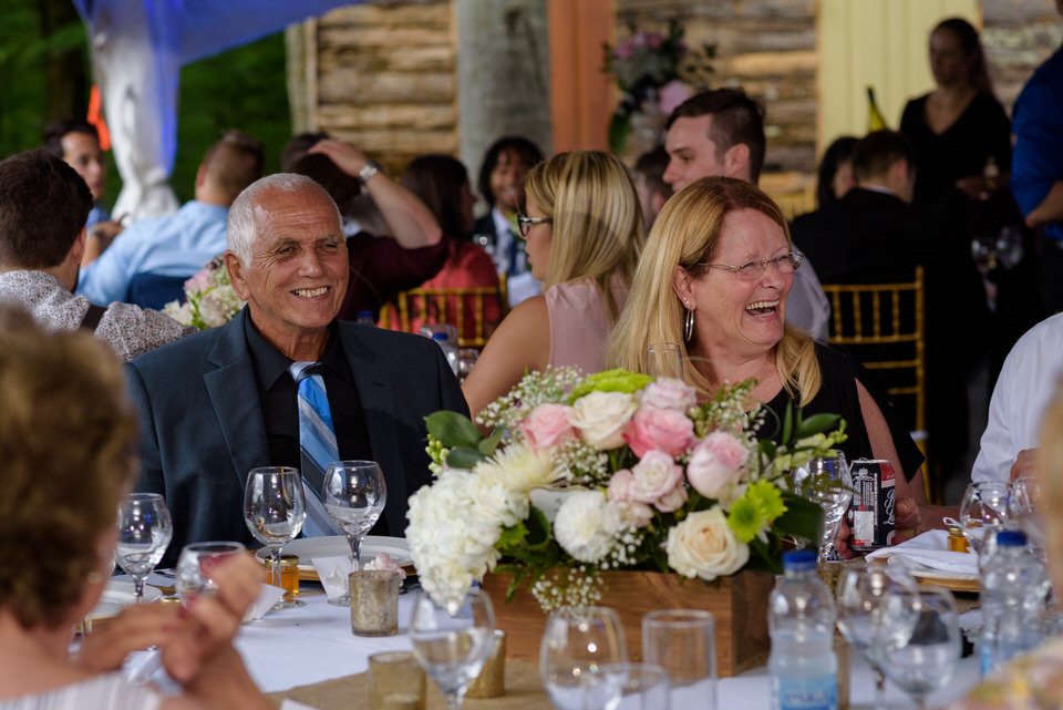 Wedding guests laughing at dinner