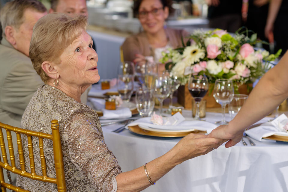 Grandmother holding bride's hand