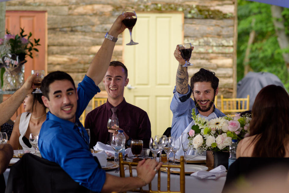 Wedding guests raising glasses in toast