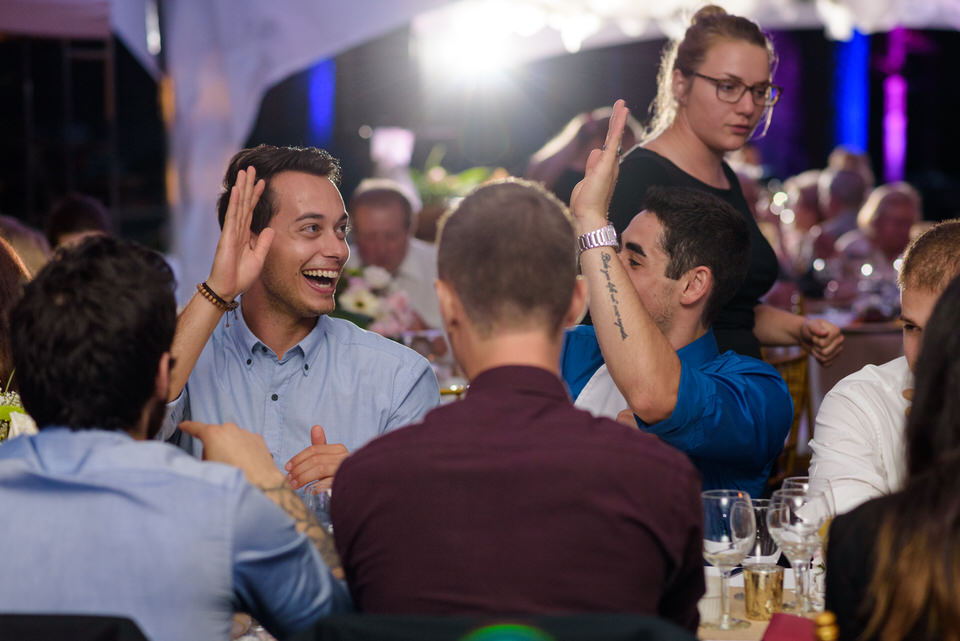 Wedding guests high fiving