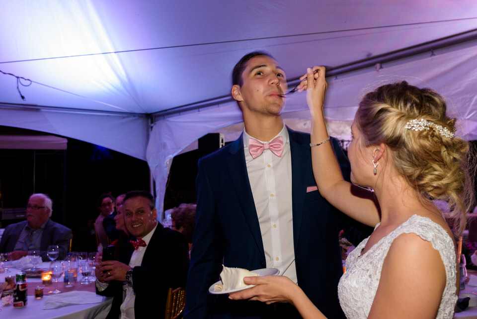 Bride feeding cake to groom