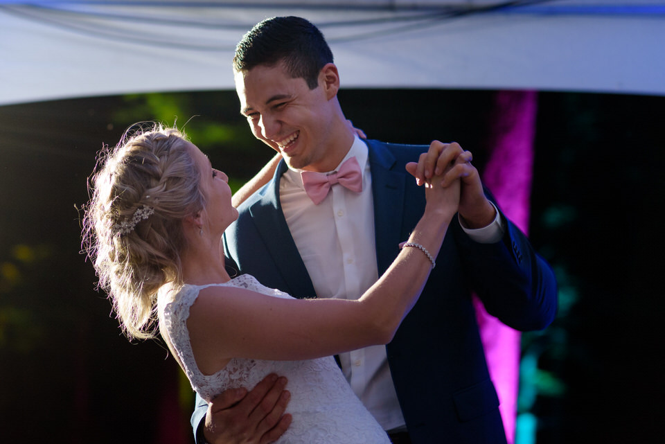 Wedding couple dancing first dance under tent