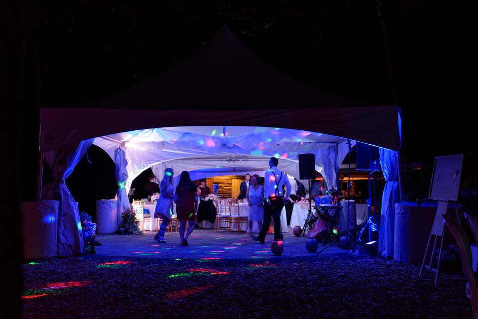 Wedding reception tent at night lit by LEDs