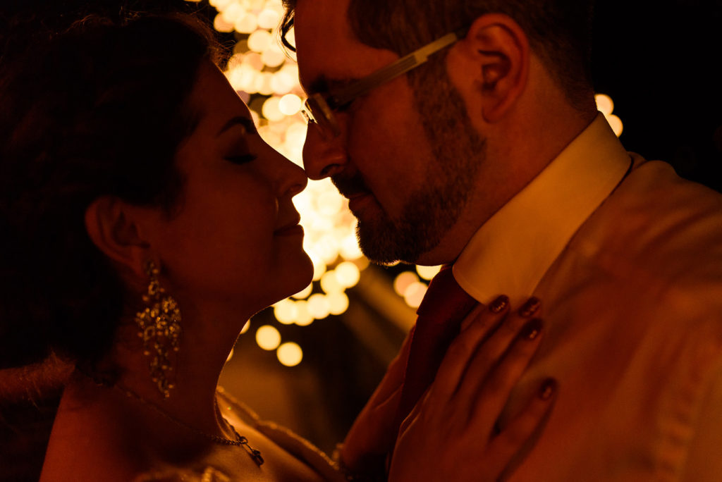 Bride and groom portrait at night under glowing lights